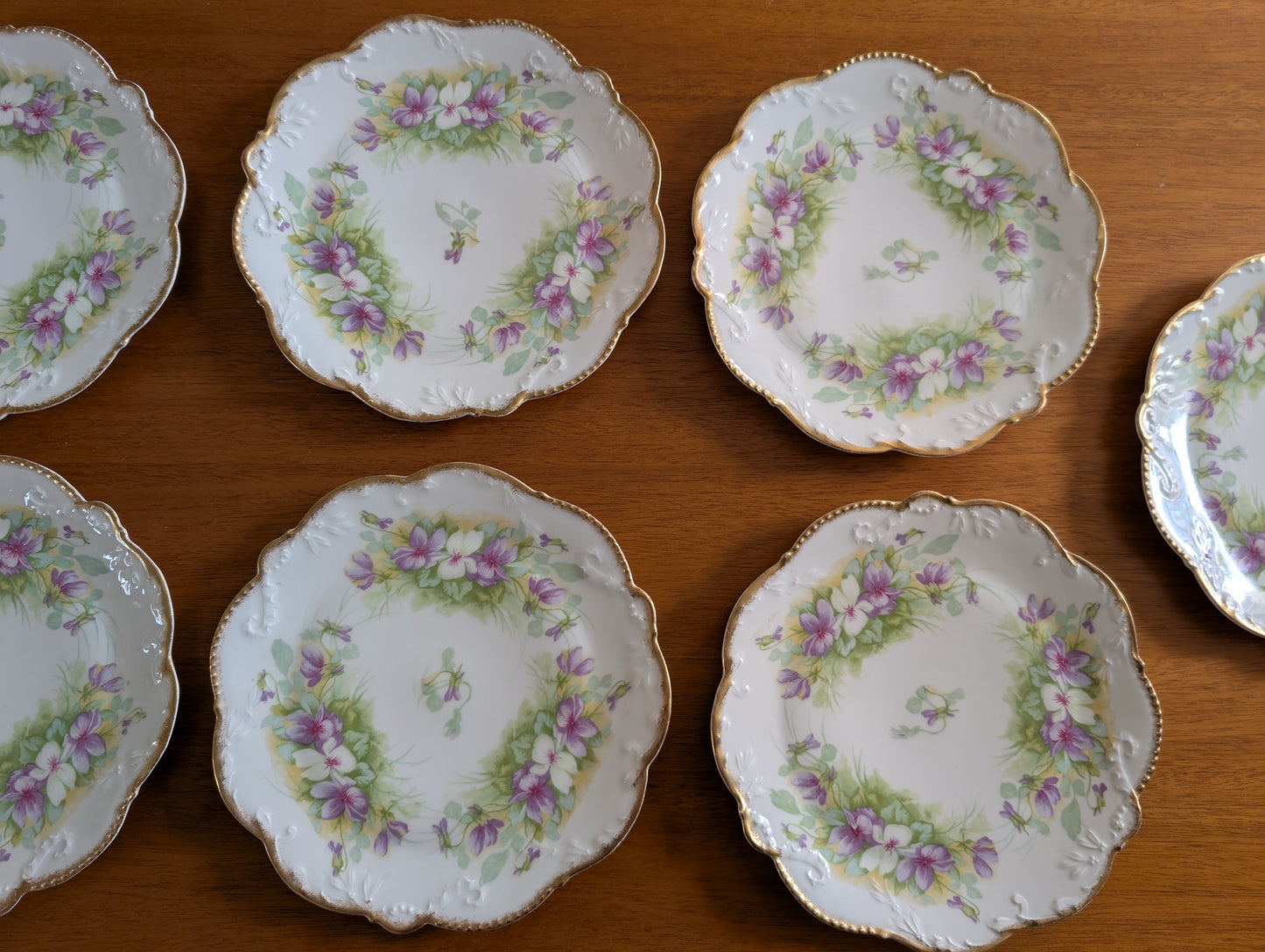 Set of 8 Limoges Coronet 8 inch Plates featuring Scalloped Gold Rims and Transferware Pansies