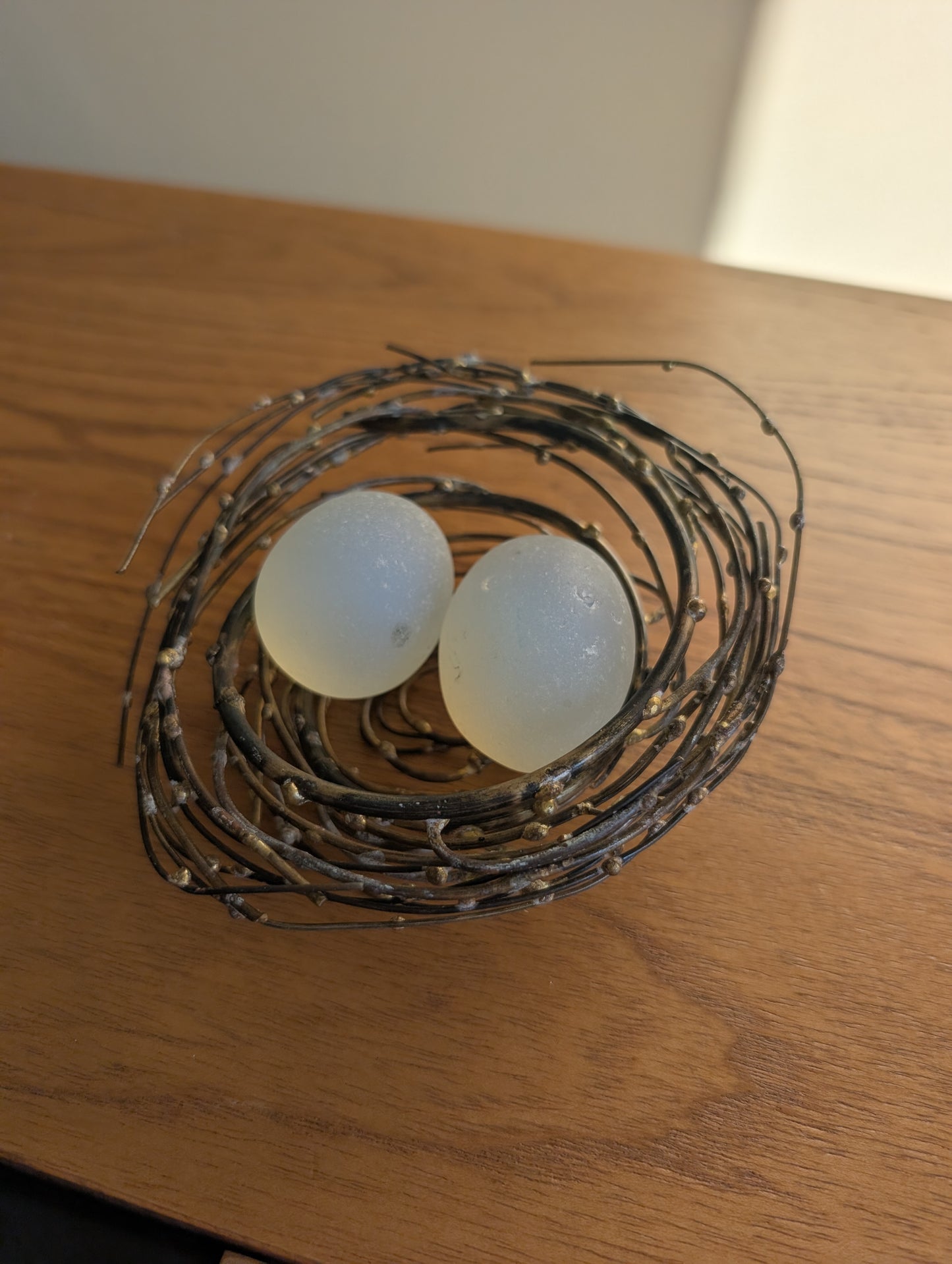 Glass or Stone Eggs in a Metal Nest
