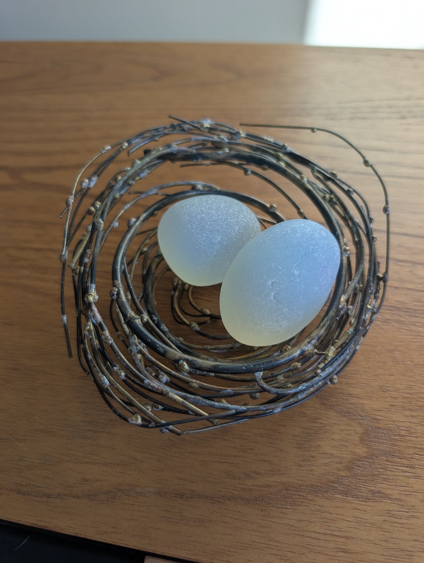 Glass or Stone Eggs in a Metal Nest