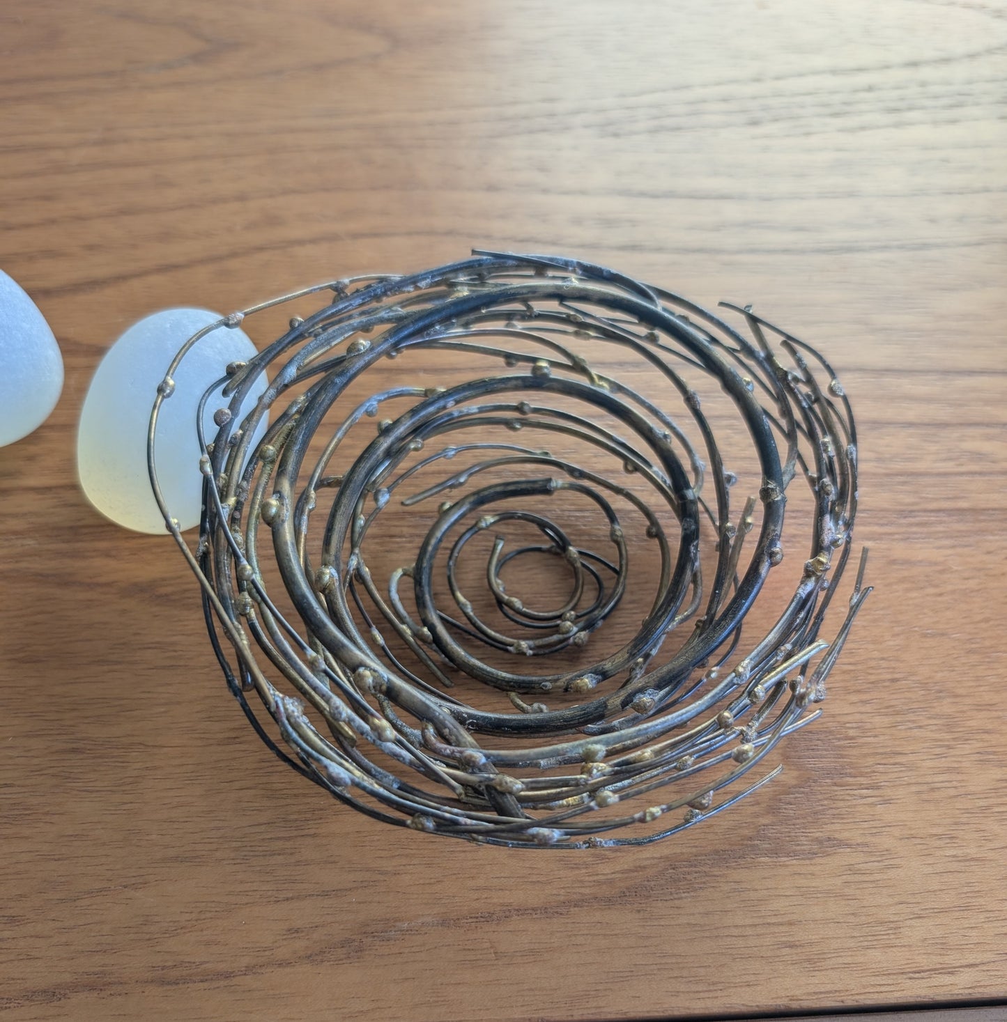 Glass or Stone Eggs in a Metal Nest