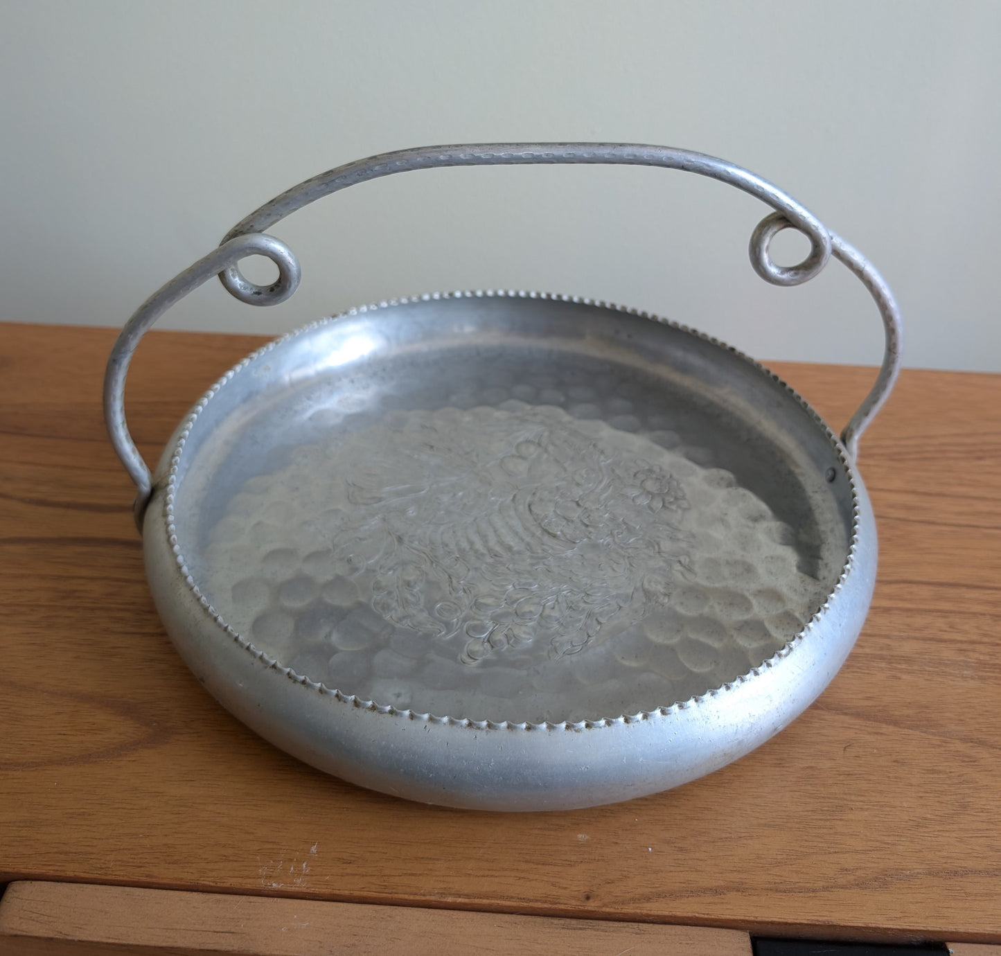 Cromwell Hammered Aluminum Round Basket with Handle Featuring a Cornucopia