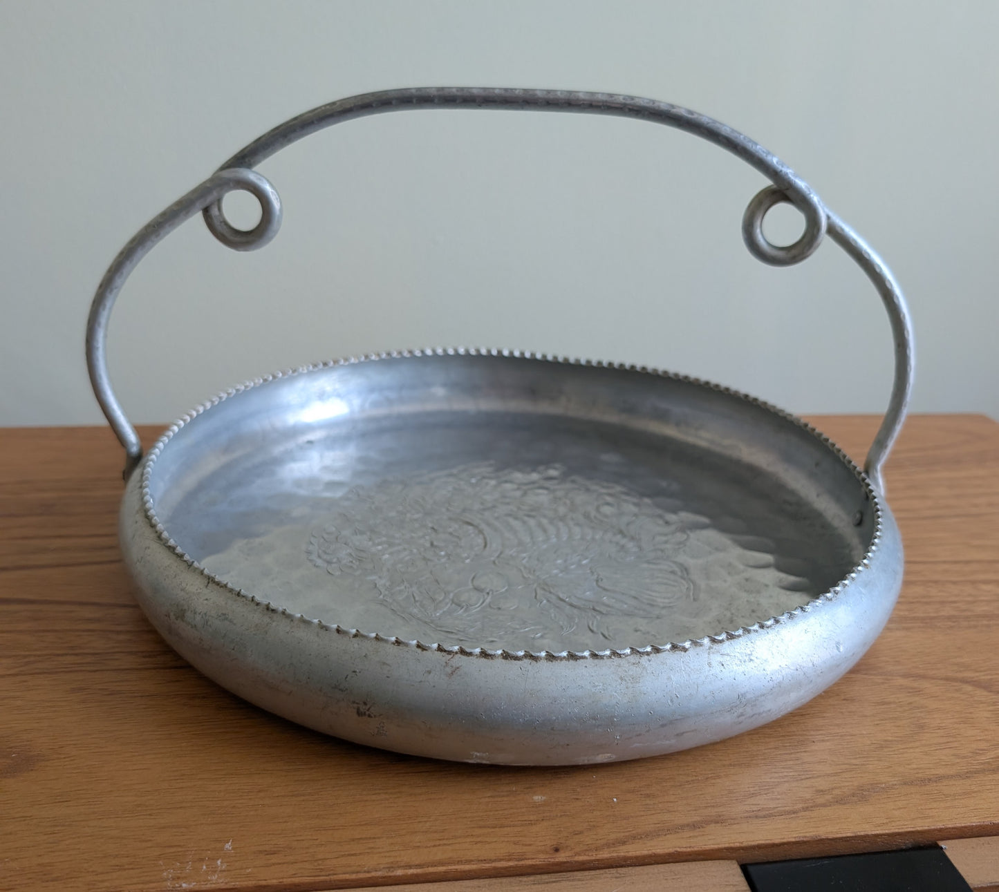 Cromwell Hammered Aluminum Round Basket with Handle Featuring a Cornucopia