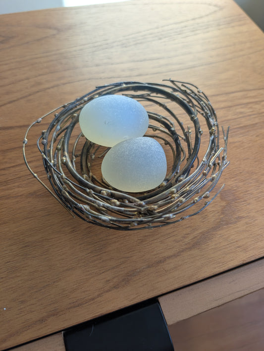 Glass or Stone Eggs in a Metal Nest
