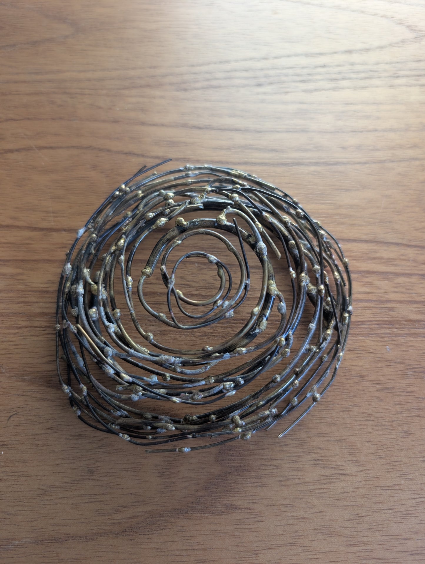 Glass or Stone Eggs in a Metal Nest