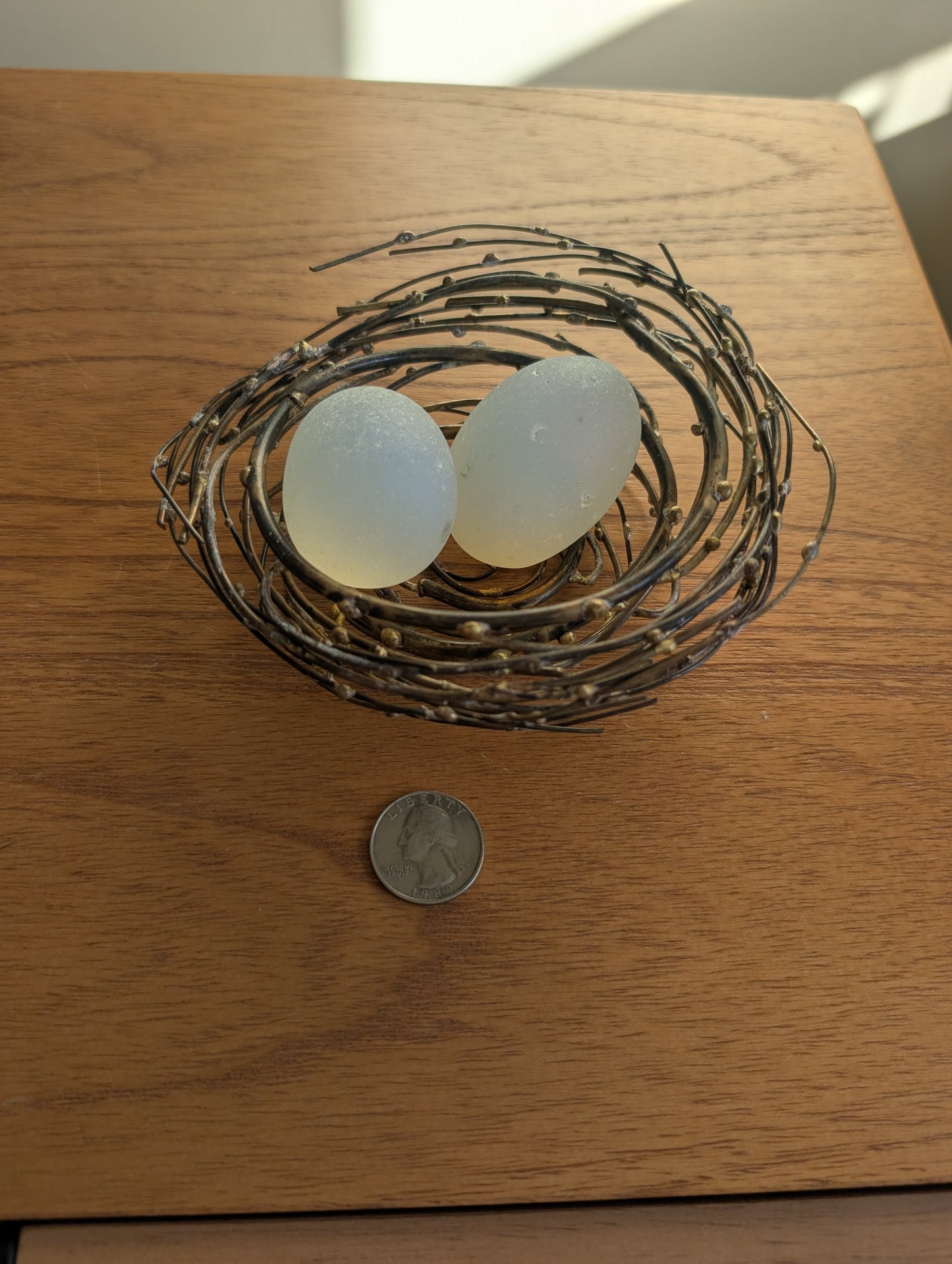 Glass or Stone Eggs in a Metal Nest